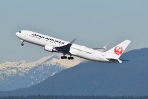A large jetliner flying through a blue sky